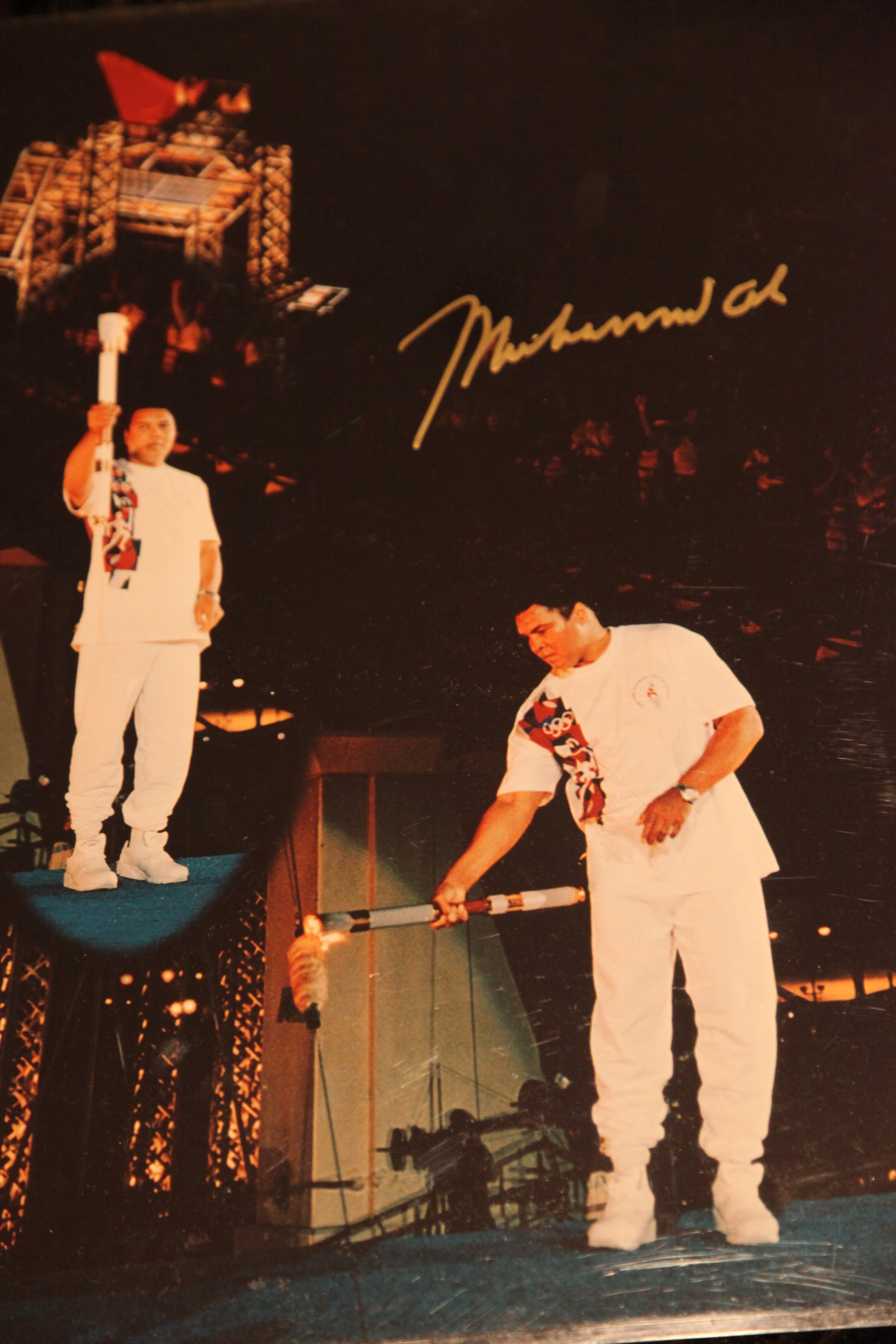 Signed 16x20 mint condition copy of Muhammad Ali lighting the Olympic Torch at the 1996 Olympic Ceremony in Atlanta